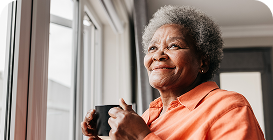 Woman in red sweater and sunglasses laughing in a car